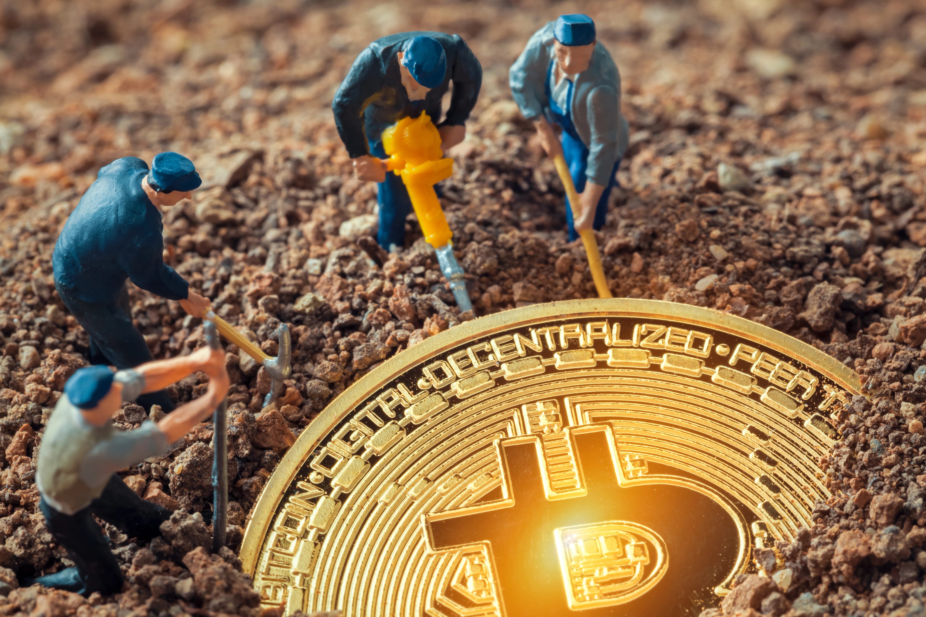Macro,Miner,Figurines,Digging,Ground,To,Uncover,Big,Shiny,Bitcoin