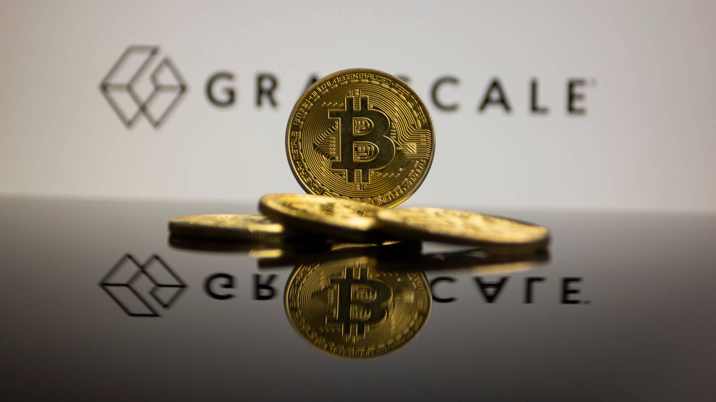 Grayscale asset manager and a bitcoin logo on a gold coin. Munich,,Germany;,January,22,,2022:,Btc,Coins,In,Front,Of